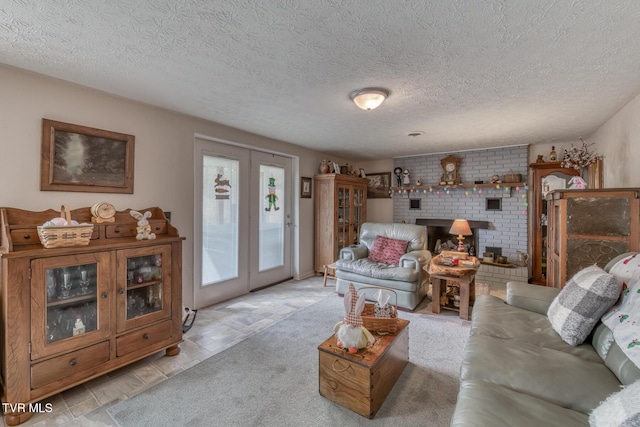 living room featuring light carpet, a textured ceiling, and a fireplace