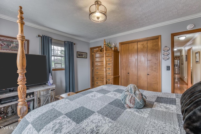 bedroom featuring a closet, a textured ceiling, and ornamental molding