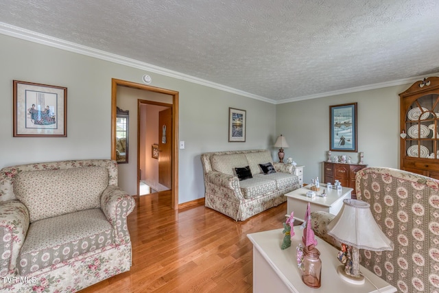 living area featuring a textured ceiling, wood finished floors, and crown molding