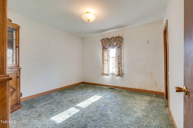 carpeted empty room with baseboards