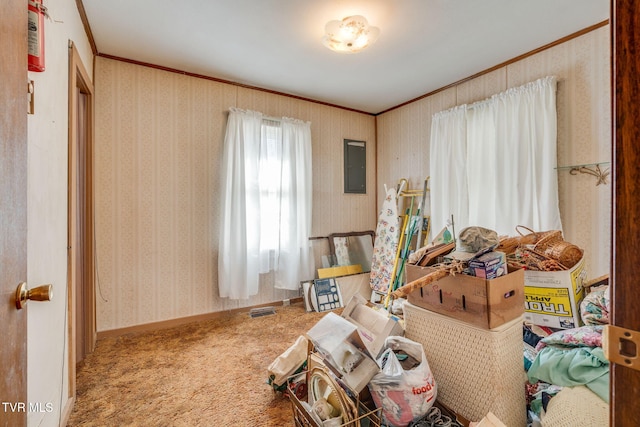 carpeted bedroom featuring wallpapered walls, electric panel, baseboards, and ornamental molding