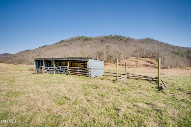 view of yard with a rural view, a mountain view, an outdoor structure, and a pole building