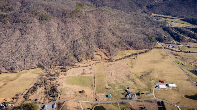 birds eye view of property featuring a rural view and a wooded view