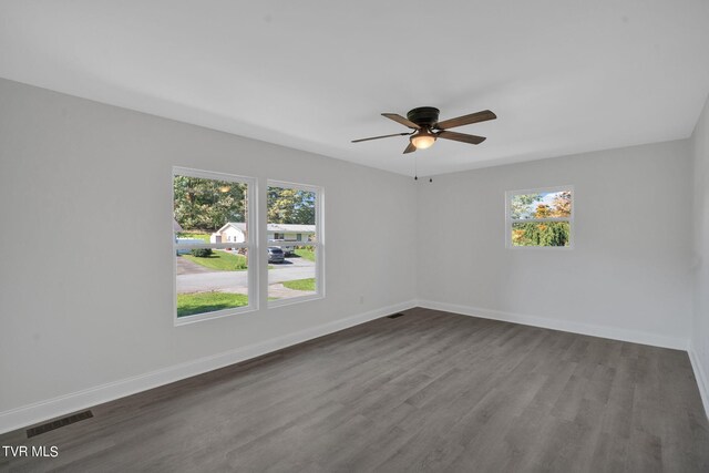 unfurnished room featuring plenty of natural light, baseboards, and visible vents