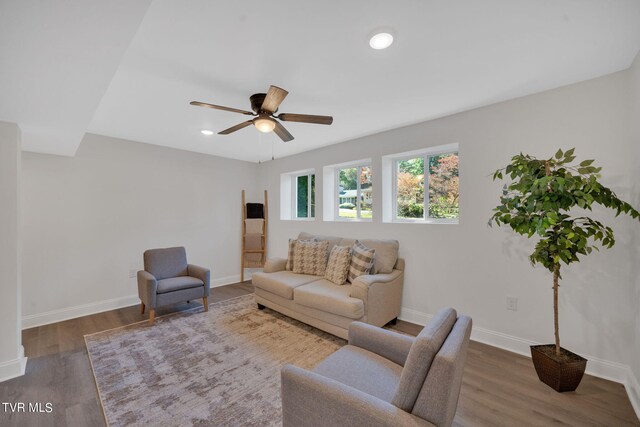 living area featuring recessed lighting, a ceiling fan, baseboards, and wood finished floors