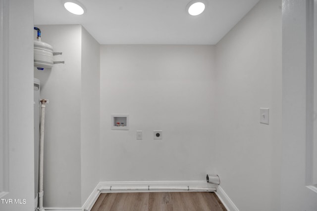 washroom featuring hookup for a washing machine, wood finished floors, baseboards, hookup for an electric dryer, and laundry area