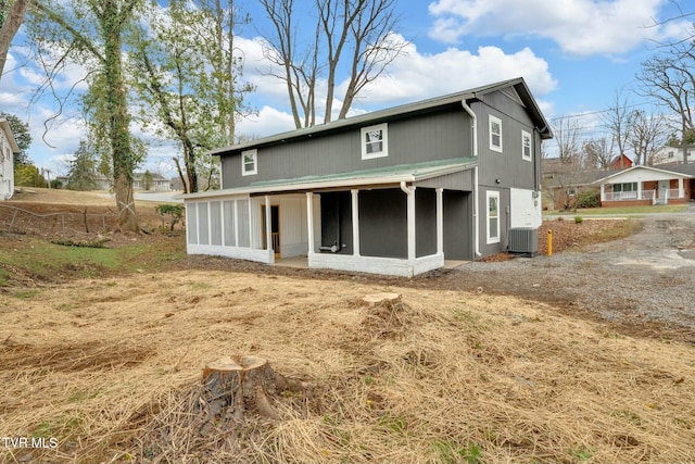 back of property featuring central AC and a sunroom