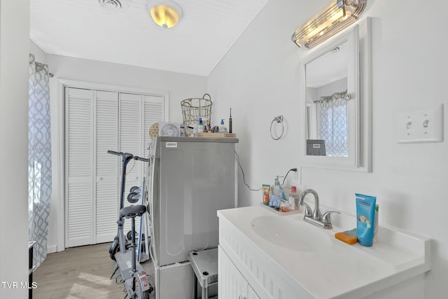 bathroom with visible vents, wood finished floors, and vanity