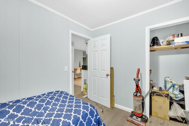 bedroom featuring wood finished floors and ornamental molding