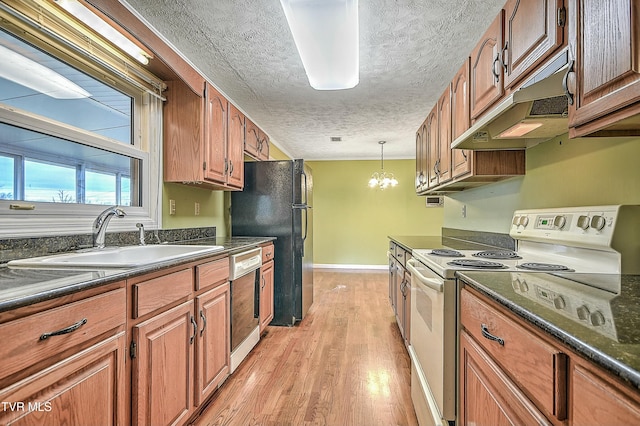 kitchen featuring a sink, under cabinet range hood, dishwasher, dark countertops, and white electric range