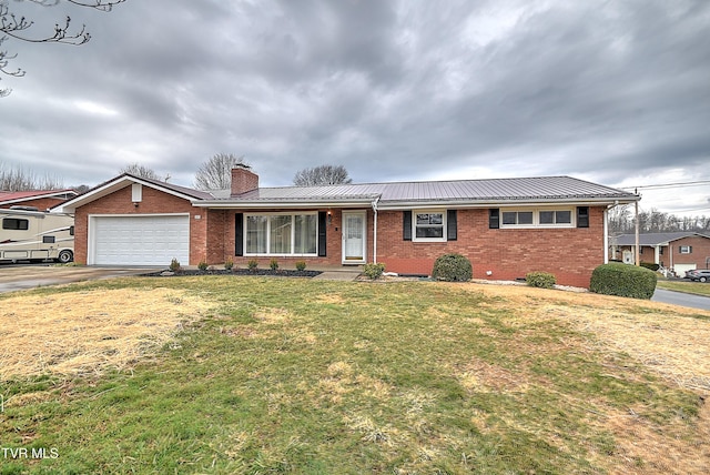 single story home featuring driveway, an attached garage, a chimney, brick siding, and metal roof