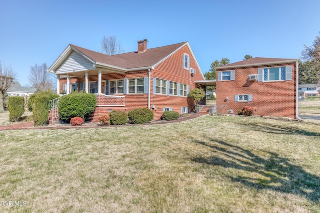 back of house featuring a yard, brick siding, and a chimney