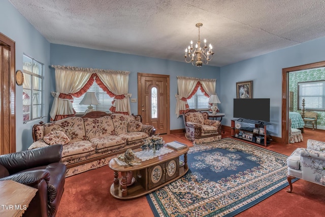 living area with baseboards, plenty of natural light, a notable chandelier, and a textured ceiling