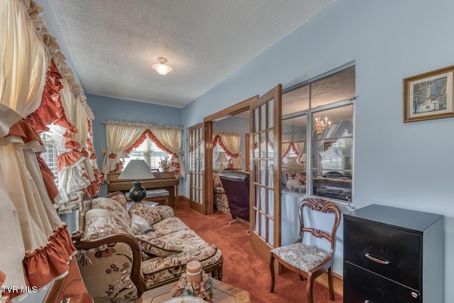 living area with french doors, carpet floors, and a textured ceiling