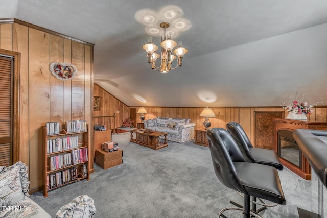 office space featuring lofted ceiling, wooden walls, a notable chandelier, and carpet