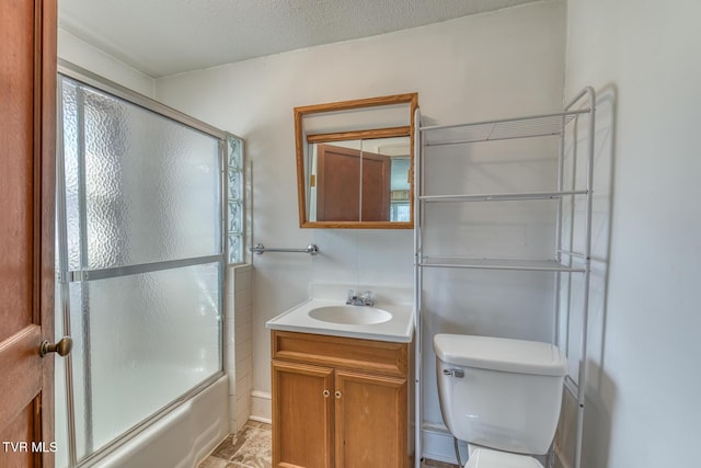 full bathroom with enclosed tub / shower combo, toilet, vanity, and a textured ceiling