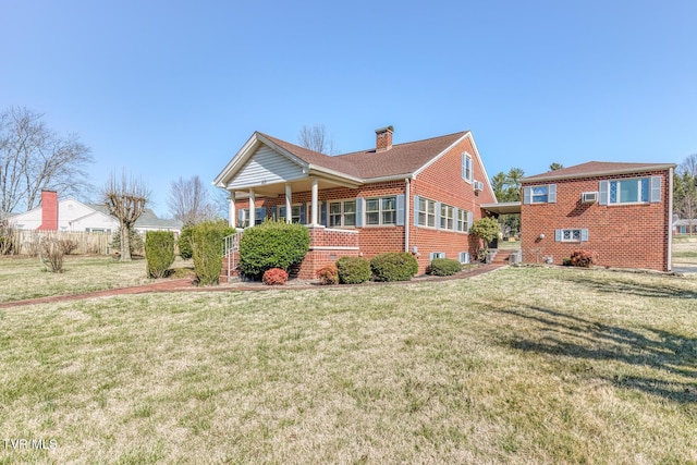 exterior space with a front lawn, brick siding, and a chimney