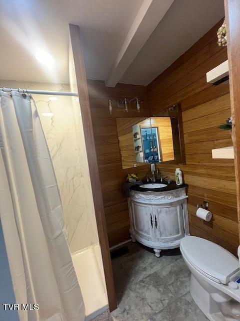 bathroom featuring vanity, wooden walls, toilet, and a shower with curtain