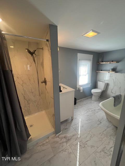 full bath with marble finish floor, toilet, and a shower stall