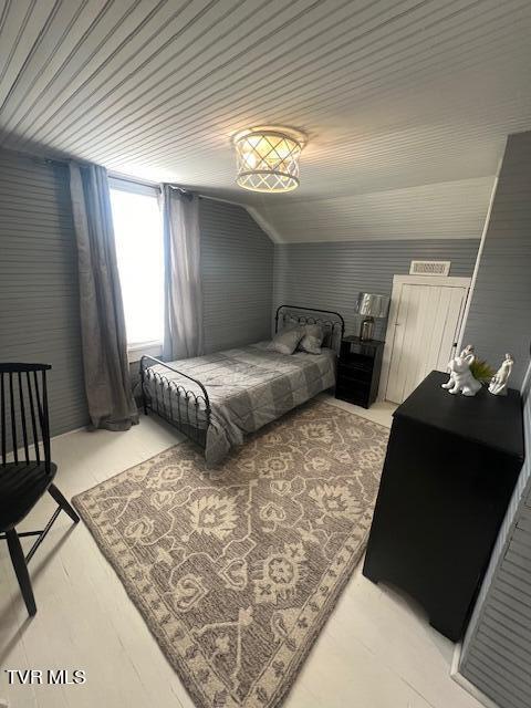 bedroom featuring vaulted ceiling and wooden ceiling