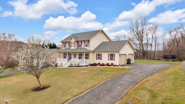 view of front of house featuring aphalt driveway, a porch, roof with shingles, a front yard, and an attached garage