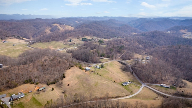 drone / aerial view with a mountain view and a forest view