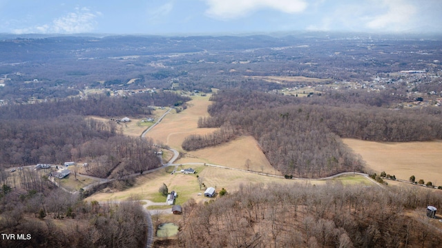 drone / aerial view featuring a rural view and a wooded view