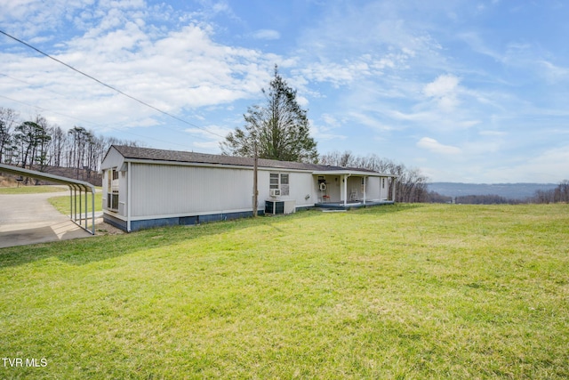 back of property featuring crawl space, cooling unit, a lawn, and a shingled roof