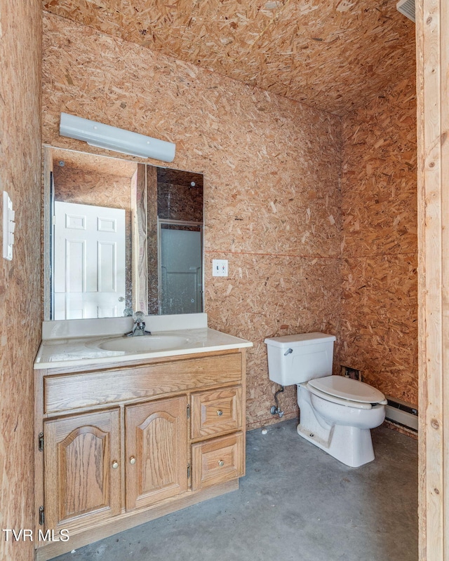 bathroom featuring a baseboard heating unit, vanity, toilet, and unfinished concrete floors