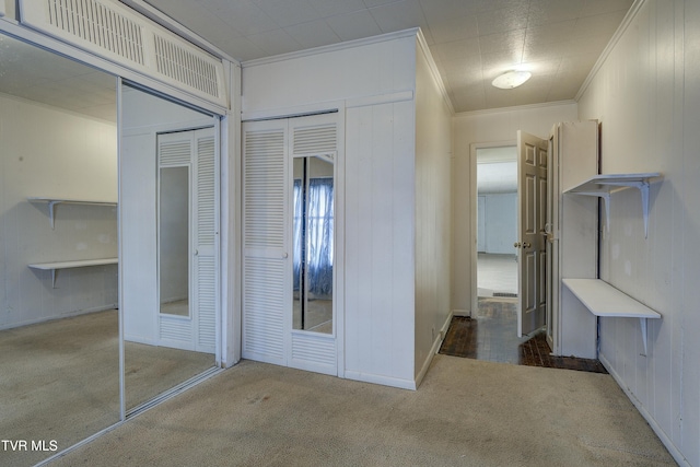 hall featuring carpet flooring and crown molding