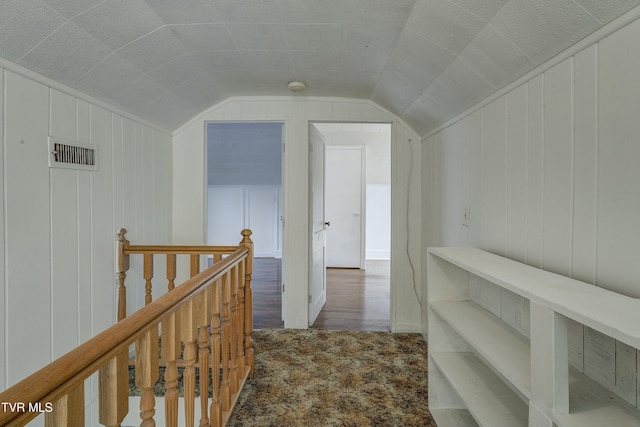 hallway featuring lofted ceiling, carpet flooring, an upstairs landing, and visible vents