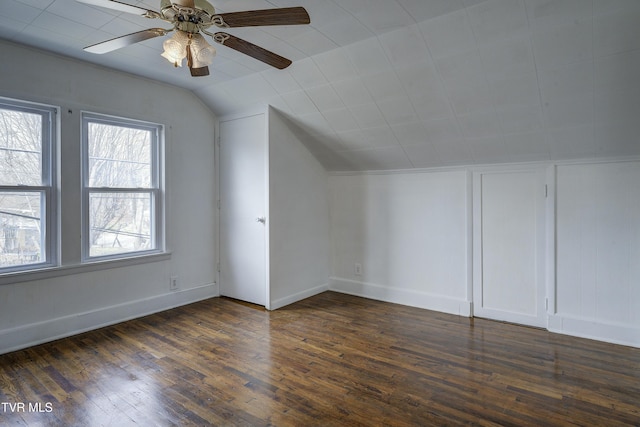 bonus room featuring vaulted ceiling, dark wood-style floors, baseboards, and ceiling fan