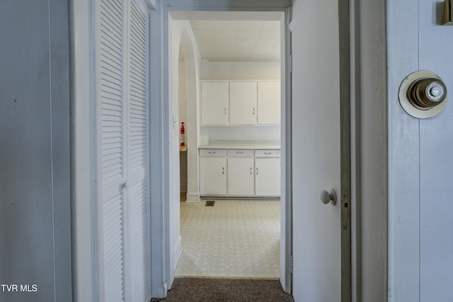 hallway featuring dark floors