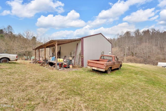 view of pole building with a yard