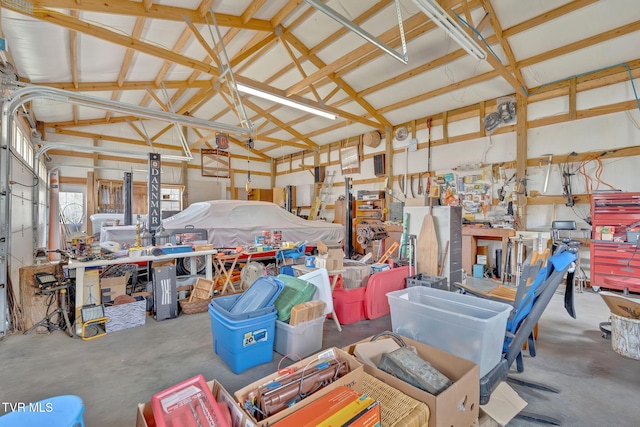 garage with a workshop area and a garage door opener