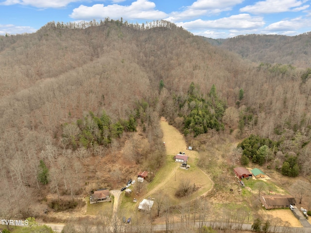 drone / aerial view featuring a mountain view and a view of trees