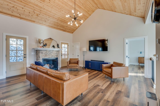 living room with wood finished floors, high vaulted ceiling, a fireplace, wooden ceiling, and a notable chandelier