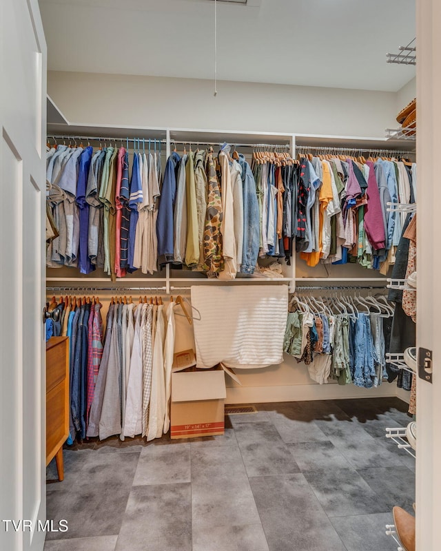 walk in closet featuring attic access