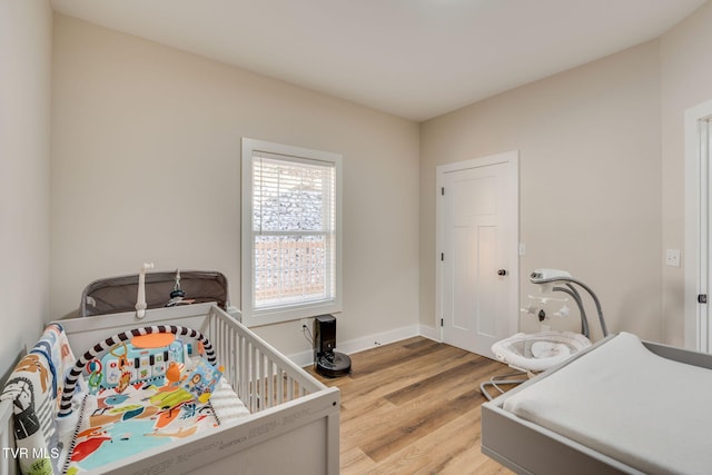 bedroom featuring baseboards and light wood finished floors