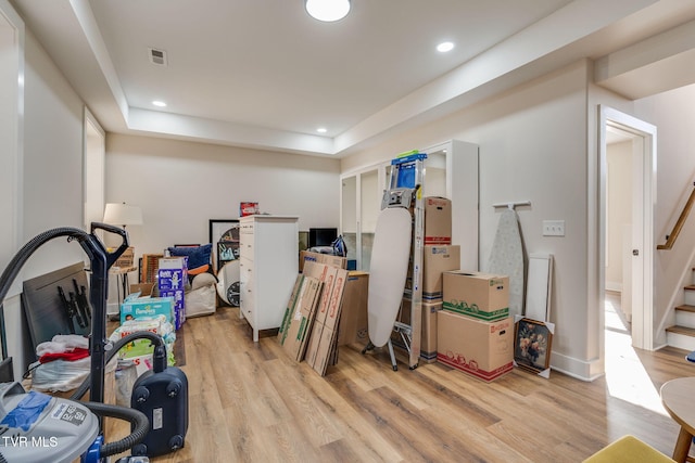 below grade area with visible vents, recessed lighting, stairway, and light wood-style floors