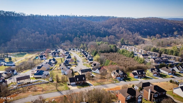 aerial view featuring a forest view and a residential view