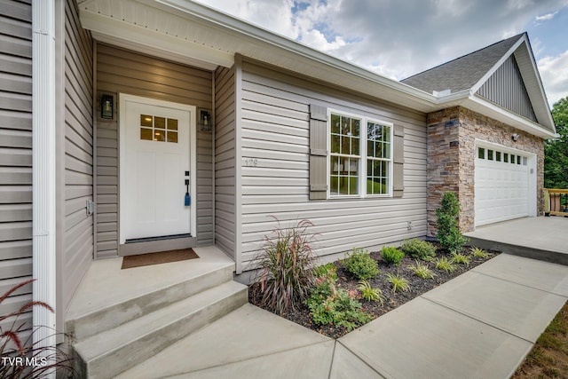 129 Stratton Pl, Kingsport, TN 37663 - view of exterior entry with an attached garage, driveway, and stone siding