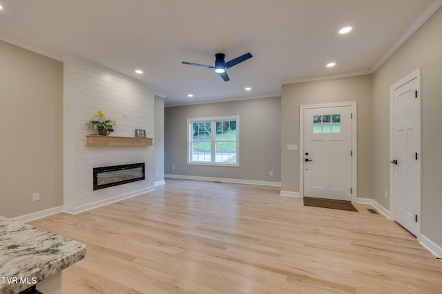 129 Stratton Pl, Kingsport, TN 37663 - entrance foyer featuring a ceiling fan, crown molding, light wood finished floors, a fireplace, and recessed lighting