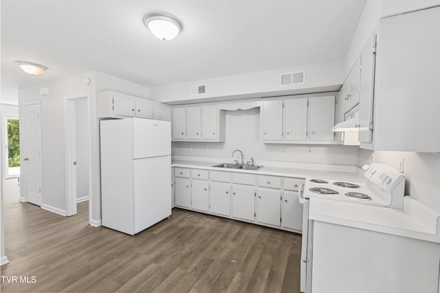 kitchen with visible vents, extractor fan, dark wood-style floors, white appliances, and a sink