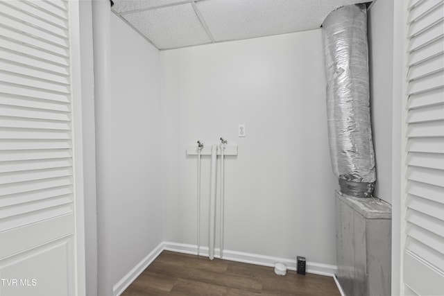 laundry room with dark wood finished floors, laundry area, and baseboards