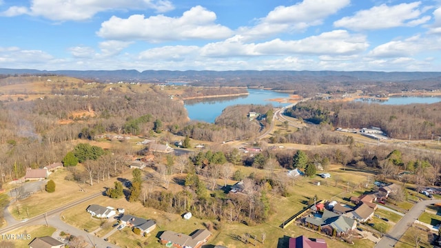 birds eye view of property with a forest view and a water view