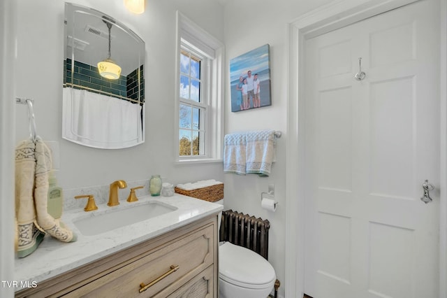 full bath featuring a shower with shower curtain, toilet, vanity, and radiator heating unit