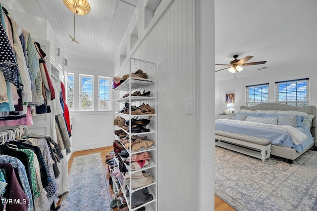 spacious closet with ceiling fan and wood finished floors