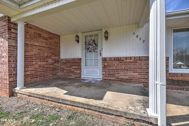 view of exterior entry with brick siding