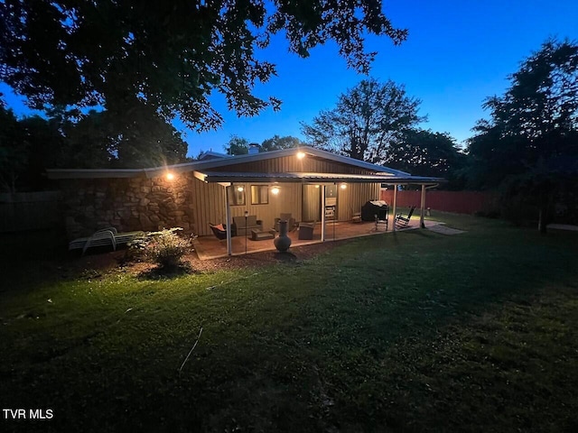 back of house with a patio, a lawn, and fence